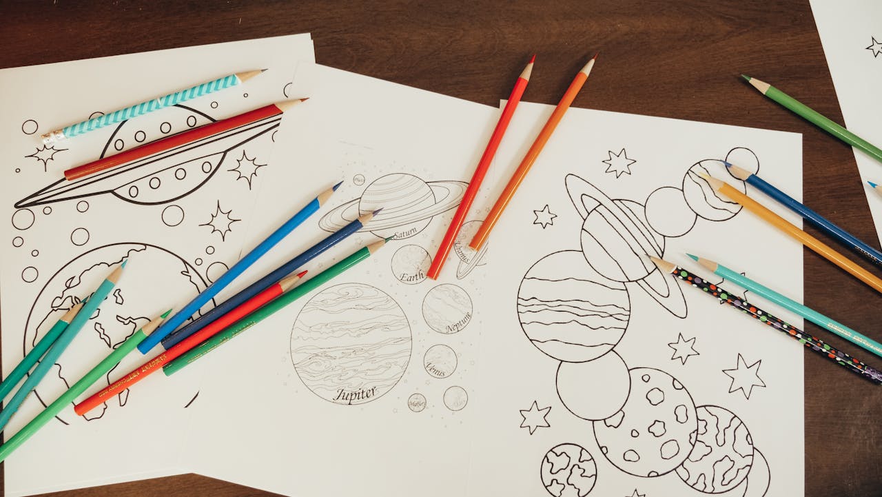 Artful planetary coloring pages with vibrant pencils for creative expression.